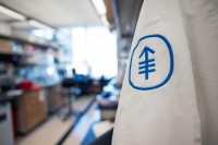 Lab coat with the MSK logo hangs in a lab
