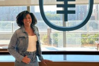 Reicy Bobadilla stands in front of a window with the MSK logo on it