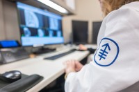 An MSK researcher reviews images on a screen