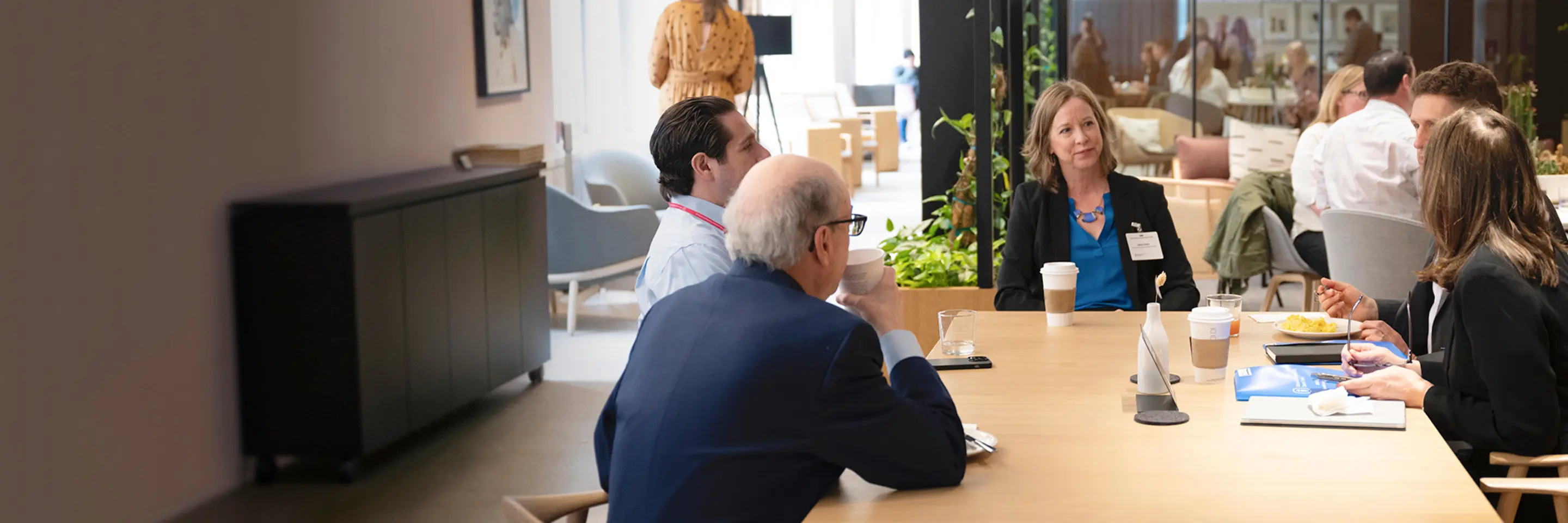 Male and female office workers having discussion in office or event environment