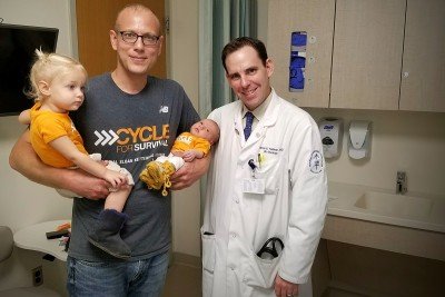 Memorial Sloan Kettering patient Jay Erickson poses with his two daughters and his MSK physician, Darren Feldman
