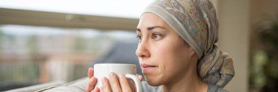 Young female cancer patient holding a tea cup