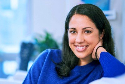 A woman relaxes on a couch