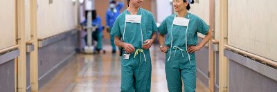 Memorial Sloan Kettering surgeon, Alice Wei, and her colleague walking down the hospital hallway dressed in their scrubs.