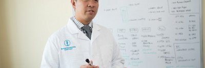 Physician standing in front of a whiteboard