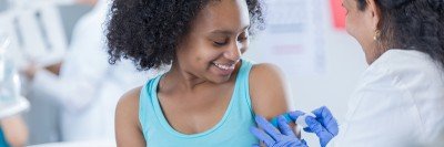 Doctor putting a band-aid on a girl's arm