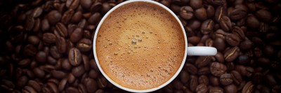 coffee cup surrounded by beans