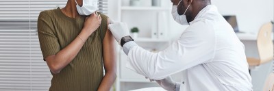 woman getting vaccine from doctor