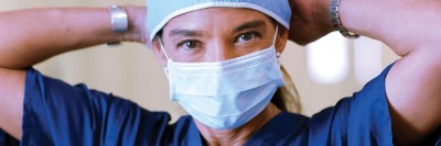 Gynecologic surgeon Carol Brown tying on a surgical cap
