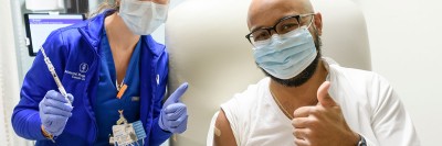 Un hombre levanta el pulgar junto a una enfermera luego de vacunarse contra el COVID-19