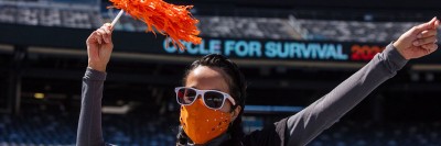 Woman waving a pom pom at the Cycle for Survival event at MetLife Stadium