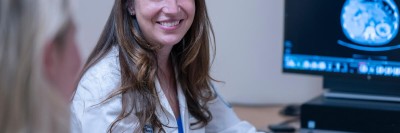 MSK gastroenterologist Robin Mendelsohn seen smiling at desk. 