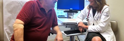 MSK hematologic oncologist Lia Palomba talking to patient.