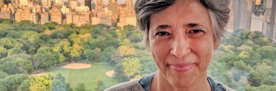 Woman smiling with Central Park in the background.