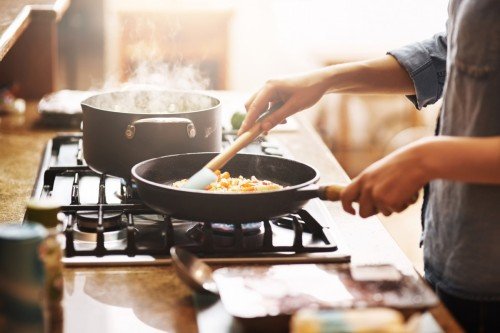 Person cooking food in a pan