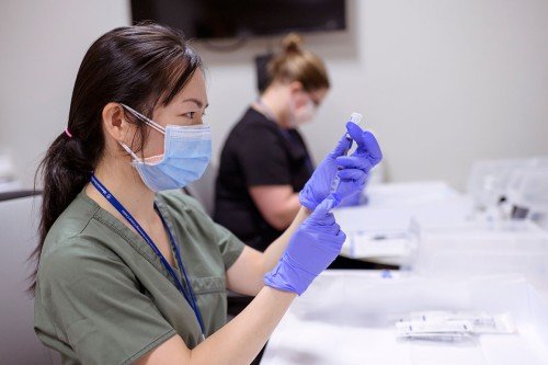 Healthcare worker prepares a vaccine