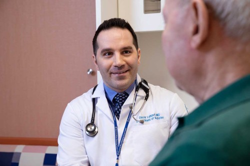 Hematologic oncologist Oscar Lahoud meets with a patient