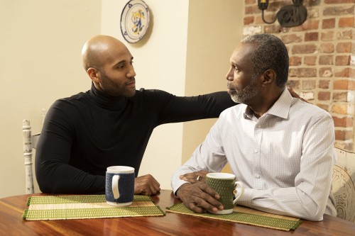 Two men sitting at a table having a discussion