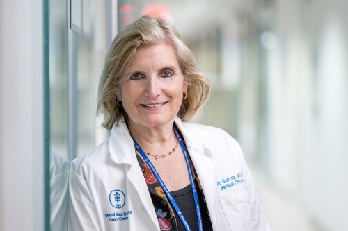 See Dr. Deb Schrag standing in a hallway. She led a clinical trial involving rectal cancer at Memorial Sloan Kettering. 