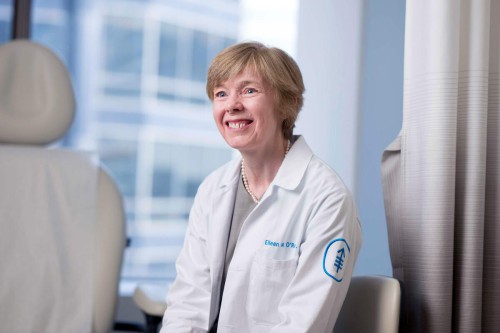Dr. Eileen O'Reilly seen smiling in an exam room. 